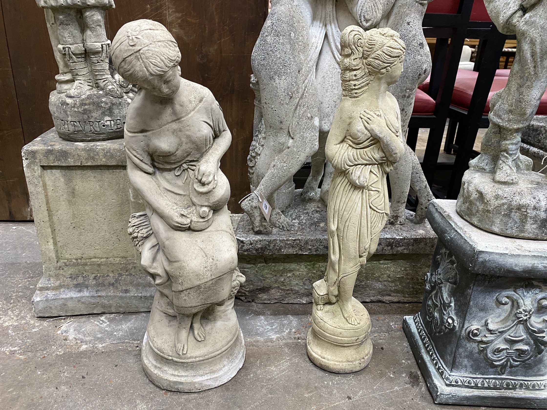 Three reconstituted stone garden statues, one on a square plinth, tallest 99cm